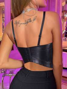 back Model wearing a black faux leather bustier crop top with structured cups, slim straps and fitted seams for festival clubwear
