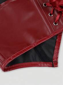 Close-up of a red faux-leather lace-up garment, showing the red fabric, silver eyelets, red ribbon laces, and a black mesh lining on a light gray background.