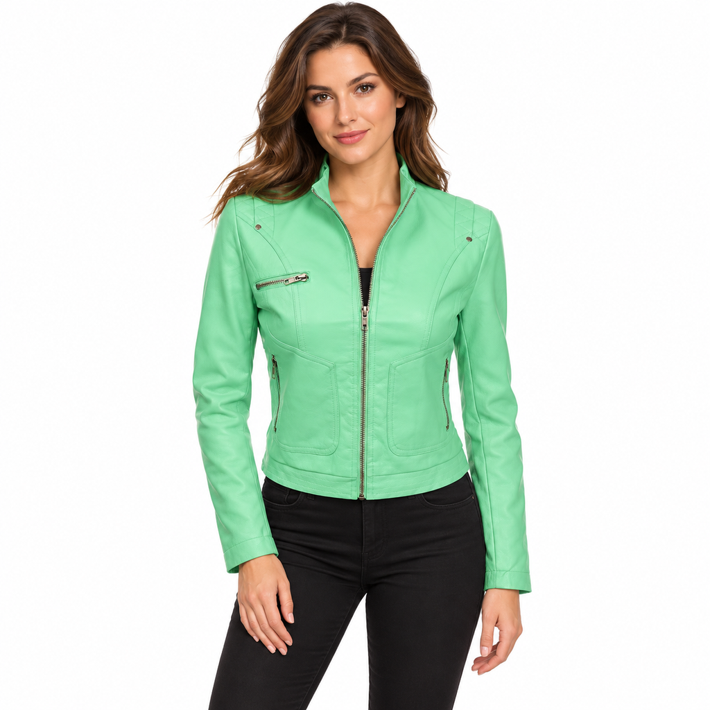 A woman modeling a mint green faux leather motorcycle jacket with silver zippers, paired with black pants, against a plain white background.